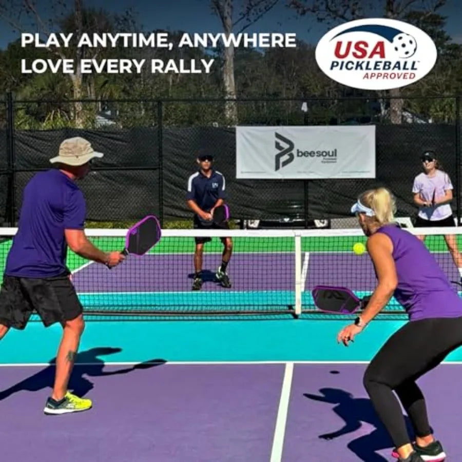 Two people playing pickleball on an outdoor court with 'USA Pickleball Approved' and 'BeeSoul' branding.
